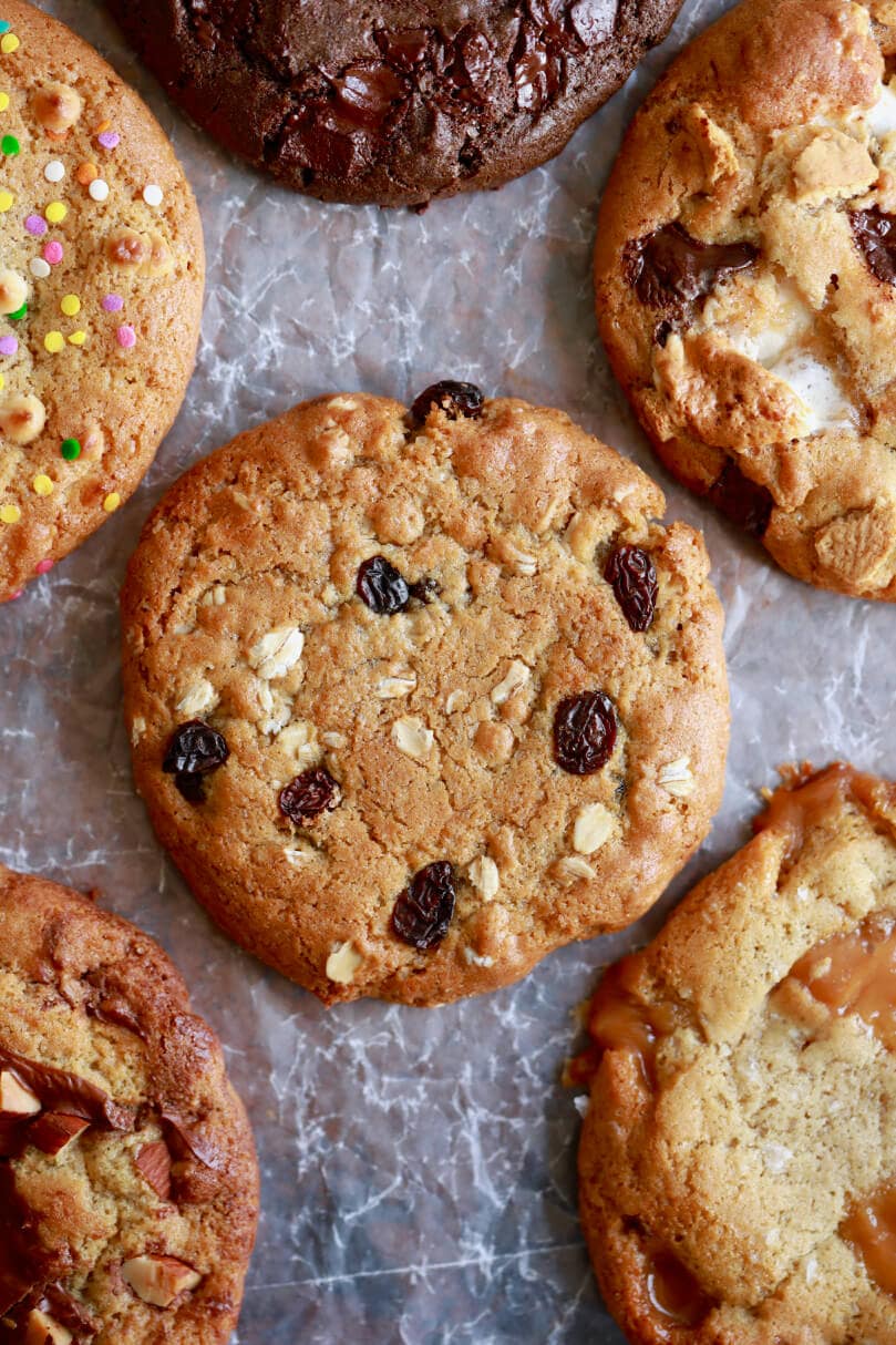 An oatmeal raisin cookie surrounded by other cookies made from just one simple cookie dough.