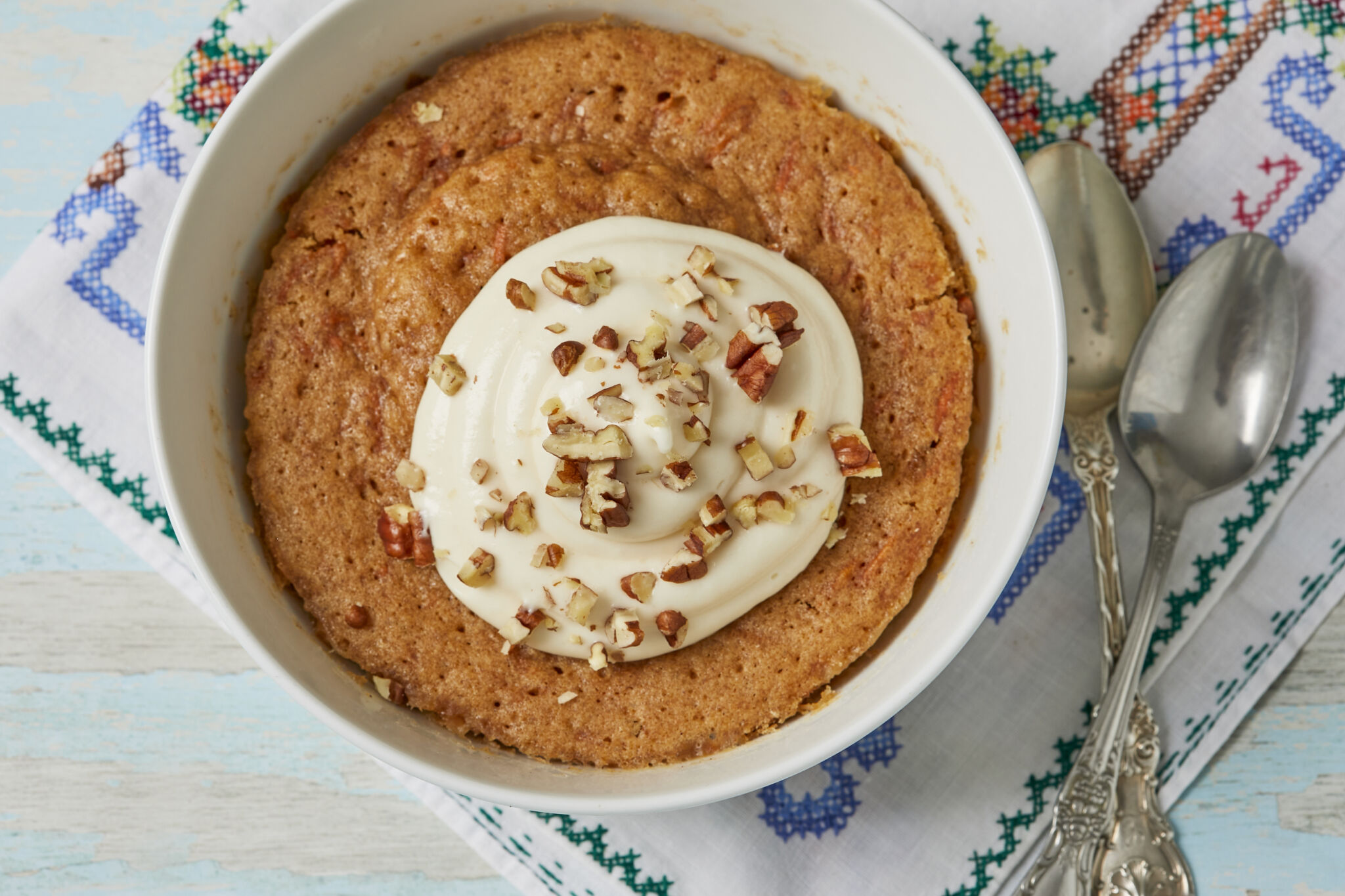 A soft, fluffy Carrot Cake, spiced with cinnamon and vanilla, topped with creamy tangy frosting and aromatic toasted nuts, made fast in one bowl!