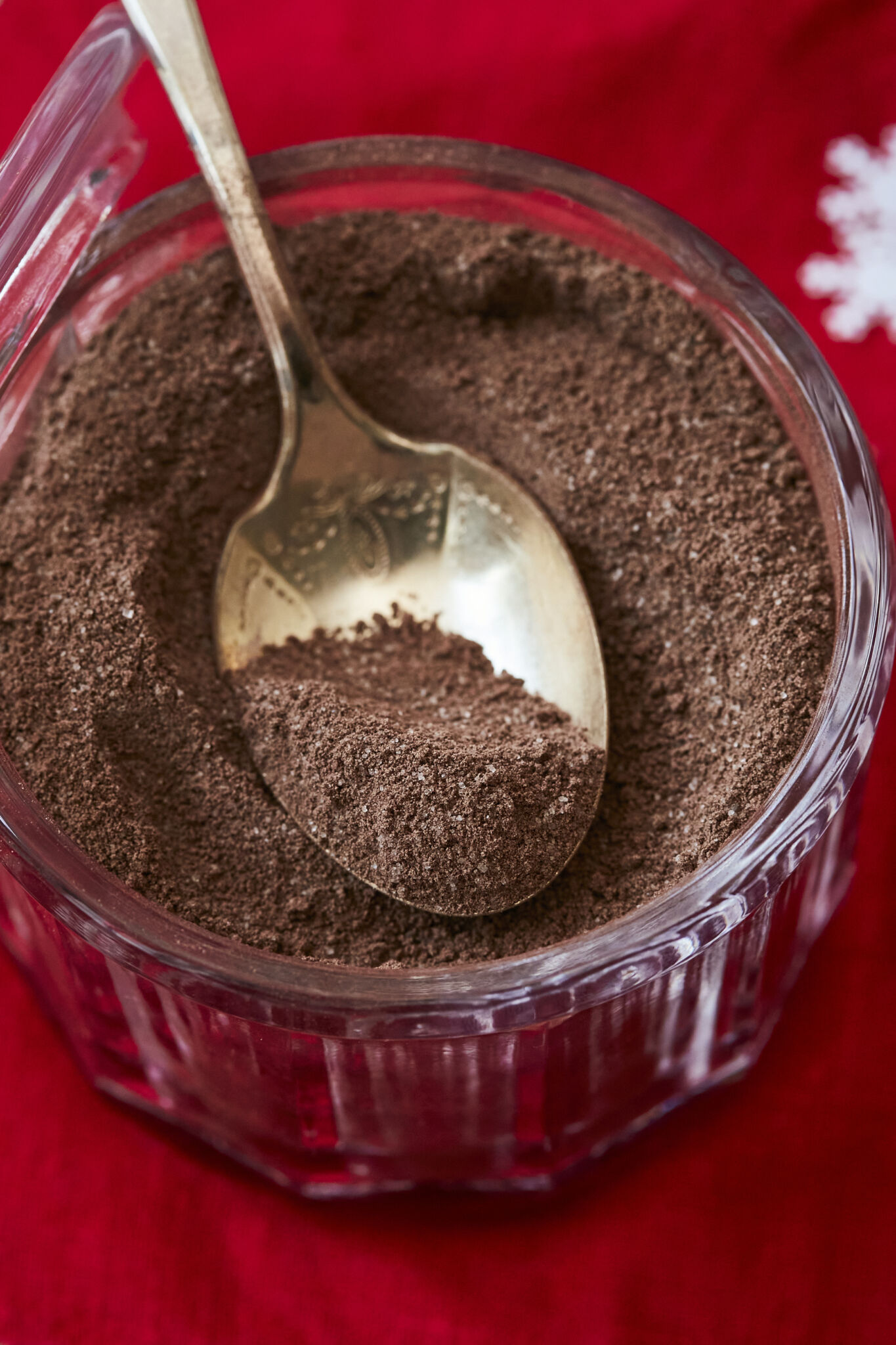 Homemade Hot Chocolate Mix in a glass jar with a golden spoon. 